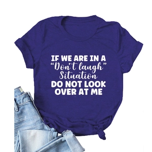 Detail of purple cotton T-shirt featuring white slogan print and stylish front knot design