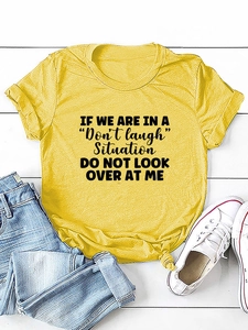 Flat lay of yellow letter print T-shirt with front knot detail and casual denim jeans