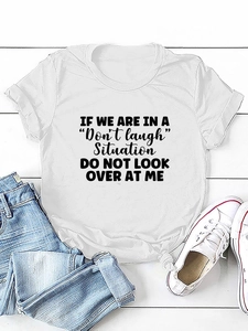 Flat lay of a white cotton t-shirt with black letter print and casual blue jeans