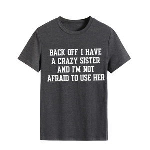 Close-up of white graphic text print on dark gray cotton short sleeve t-shirt