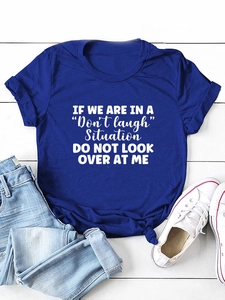 Flat lay detail of a royal blue crew neck t-shirt with white 'Don't Laugh' typography print