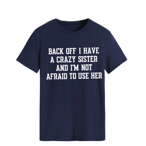 Detail of navy crew neck T-shirt with 'BACK OFF I HAVE A CRAZY SISTER' text print