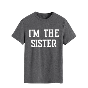 Détail de l'imprimé blanc I'M THE SISTER sur le t-shirt en coton gris foncé à col rond
