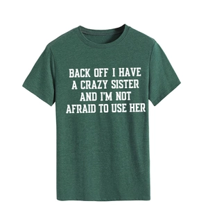 Detail of a dark green cotton T-shirt featuring a bold white slogan print on the front