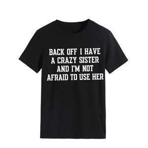 Detail of black crew neck T-shirt featuring a bold white serif text slogan print