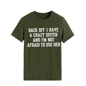 Close-up of military green crew neck T-shirt with white 'Crazy Sister' slogan print