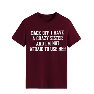 Detailed close-up of dark red crew neck t-shirt with white letter print and neat collar seams