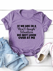 Detail of purple cotton T-shirt with humorous letter print and stylish front knot hem