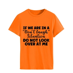 Detail of orange t-shirt featuring black printed text with a classic round neckline