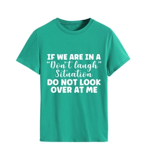 Detail of teal crew neck t-shirt with white 'Don't laugh' slogan print on fabric