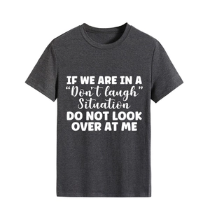 Detail of white slogan print on a dark gray cotton crewneck t-shirt fabric