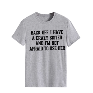 Detail of grey crewneck T-shirt with 'BACK OFF I HAVE A CRAZY SISTER' text print