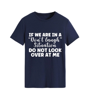 Detail of navy blue cotton t-shirt featuring white slogan print and round neckline