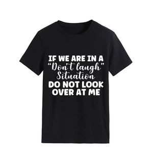 Detail of white slogan print on black crew neck cotton t-shirt with clear text texture
