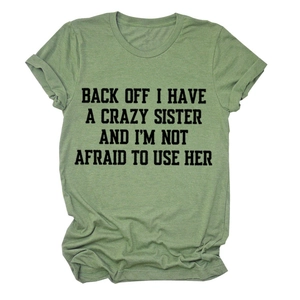 Detail of moss green t-shirt featuring black bold text print and rolled sleeve design