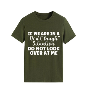 Detailed view of white slogan print on olive green crew neck cotton t-shirt fabric