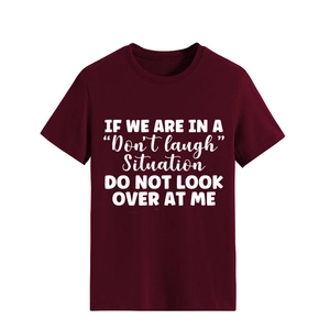 Detail of burgundy cotton T-shirt featuring white 'Don't laugh' slogan print