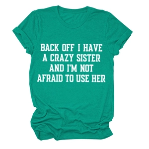 Detail of green heather t-shirt featuring bold white slogan text and crew neck collar