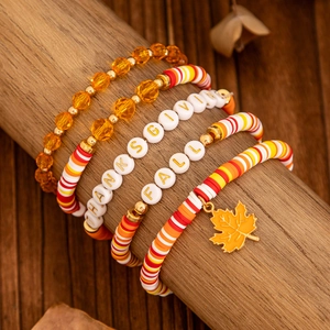 Detail of Thanksgiving stretch bracelets with fall letter beads and maple leaf charm