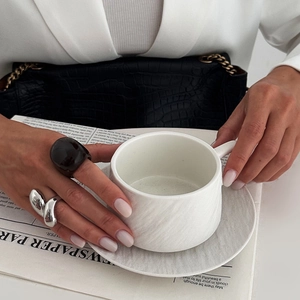 Chic vintage resin and silver metal wave ring set styled with a modern city aesthetic