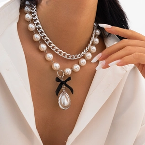 Fashionable layered necklace with pearl chain, silver Cuban links and bow drop pendant