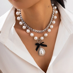 Double-layer necklace with silver curb chain, white pearls, black bow and drop pendant