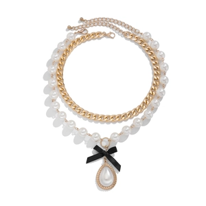 Layered gold chain and faux pearl necklace set with black bow and teardrop pendant