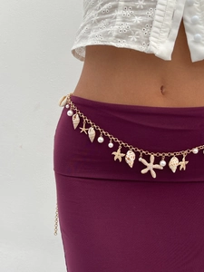 Detailed view of Bohemian gold waist chain with seashell, starfish and pearl charms