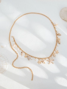Detail of beach-style waist chain featuring golden starfish, shells, and white pearls