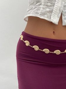 Close-up of golden shell body chain featuring detailed seashell charms for beach style