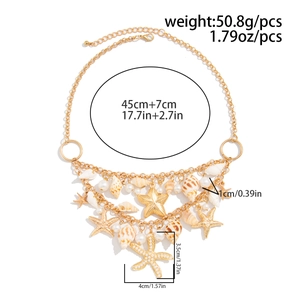 Detail of layered gold necklace with starfish, shell charms and white pearls