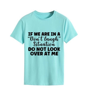 Detail of mint green cotton t-shirt featuring black 'Don't laugh' slogan print