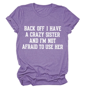 Detail of purple crew neck T-shirt with white bold slogan print and soft cotton texture