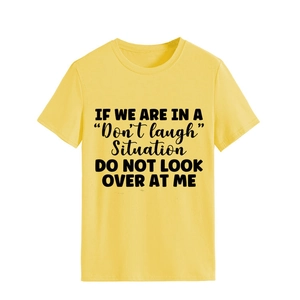 Close-up of a casual yellow crewneck T-shirt featuring bold black letter printing