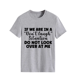 Close-up of the grey t-shirt featuring black block letter slogan print on soft fabric
