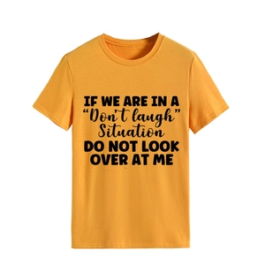 Detail of crewneck mustard yellow cotton T-shirt featuring bold black slogan print