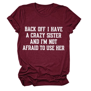 Detail view of the bold white letter print on a dark red crew neck short sleeve T-shirt