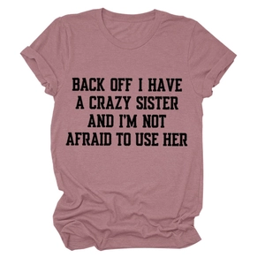 Detail of mauve crew neck t-shirt featuring bold letter print and rolled cuff sleeves