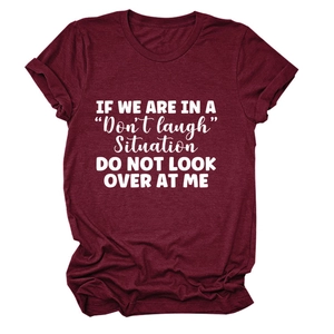 Detail of burgundy cotton t-shirt featuring white slogan print 'DO NOT LOOK OVER AT ME'