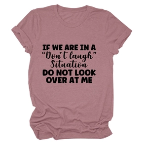 Detail of artistic black typography on dusty pink casual short sleeve cotton t-shirt