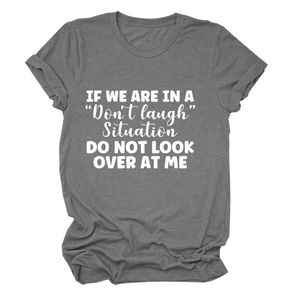 Detail of grey cotton blend t-shirt featuring white slogan print and cuffed sleeves