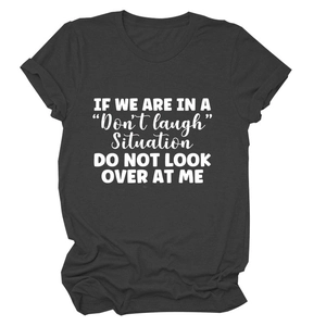 Detail of letter print on dark grey cotton T-shirt with 'Don't laugh' slogan