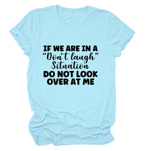 Macro detail of high-quality light blue cotton t-shirt with black graphic slogan print