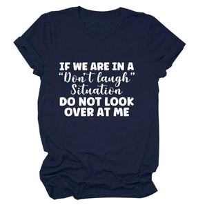 Detail of navy blue cotton t-shirt featuring white artistic letter print and round neck
