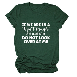 Detail of dark green cotton T-shirt featuring a stylish white slogan printed on the chest