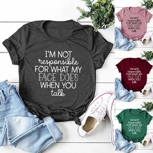 Flat lay of colorful crew neck slogan t-shirts showing black, pink, red, and green options
