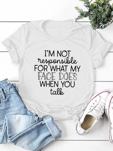 Flat lay of white cotton T-shirt with black slogan print, jeans and white sneakers