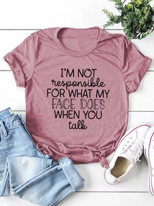 Flat lay of pink cotton T-shirt with I'm Not Responsible slogan and casual accessories