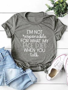 Flat lay of heather grey t-shirt with I'M NOT responsible slogan on white wooden background