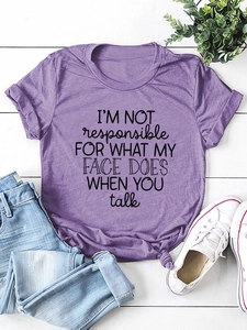Flat lay of purple cotton T-shirt with vintage black typography quote on wood background
